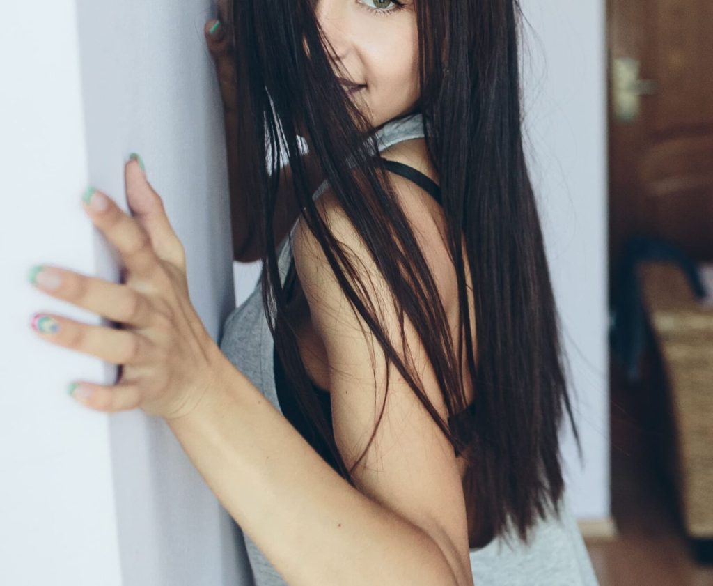 attractive-young-woman-posing-with-wall